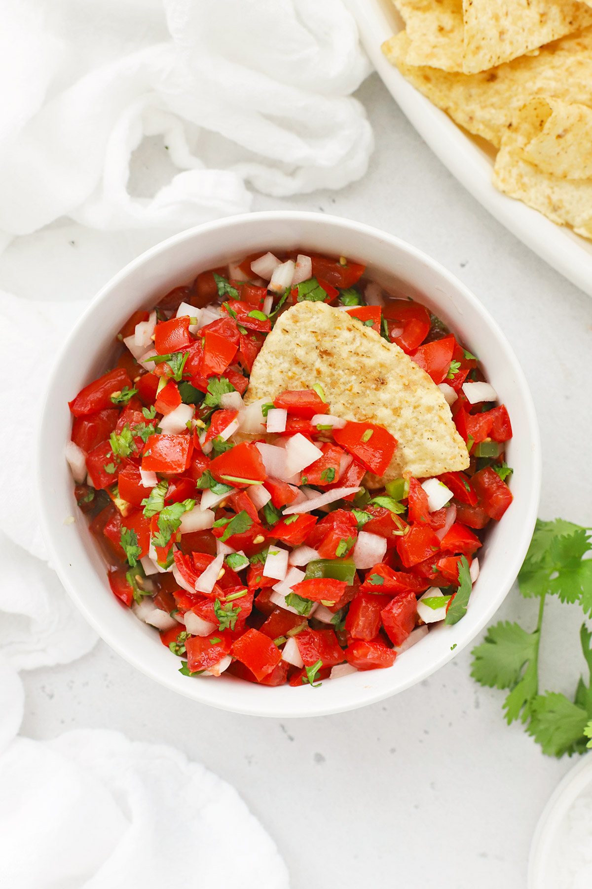 Overhead view of a bowl of authentic pico de gallo with chips