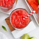 Overhead view of Watermelon Slushies in Glasses with Red and White Striped Straws
