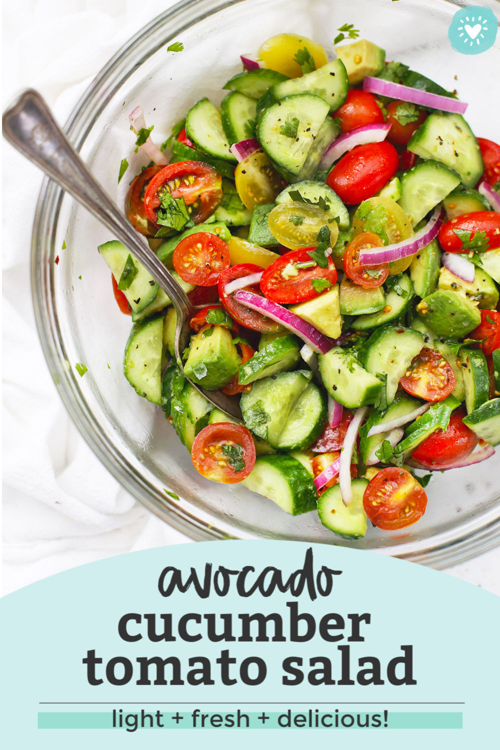 with text overlay that reads "avocado cucumber tomato salad. Light + fresh + delicious!"