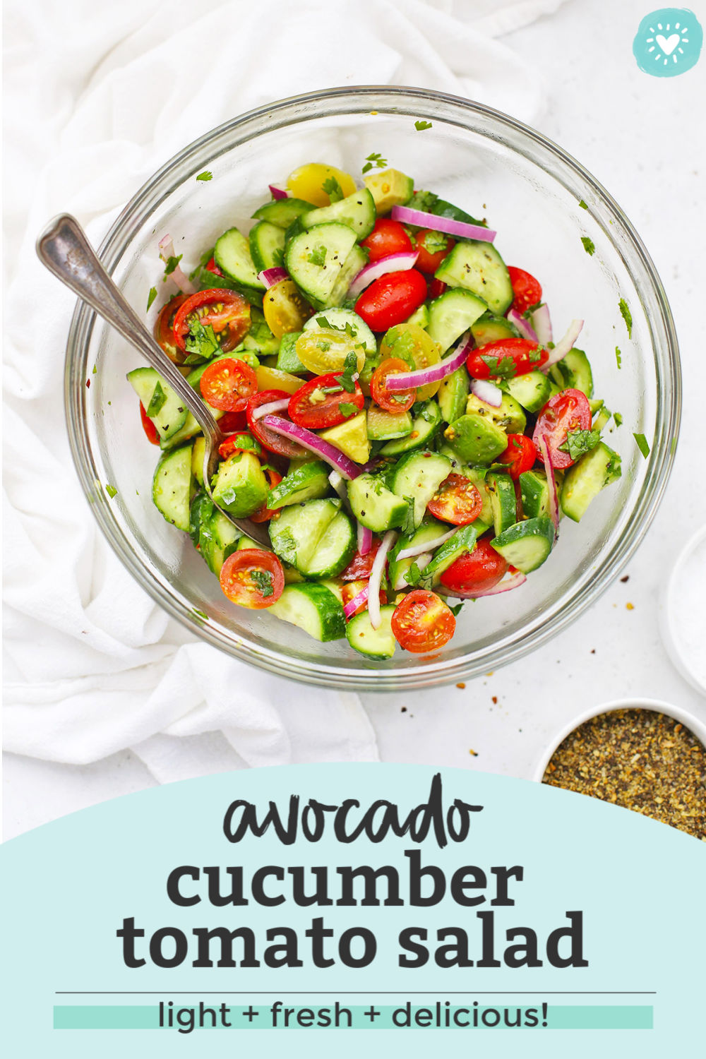 with text overlay that reads "avocado cucumber tomato salad. Light + fresh + delicious!"