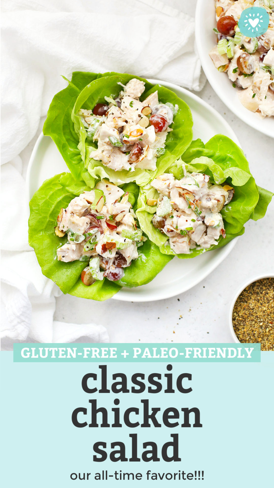Three chicken salad lettuce wraps on a plate with text overlay that reads "Gluten-Free + Paleo-Friendly Classic Chicken Salad. Our all-time favorite!!!"