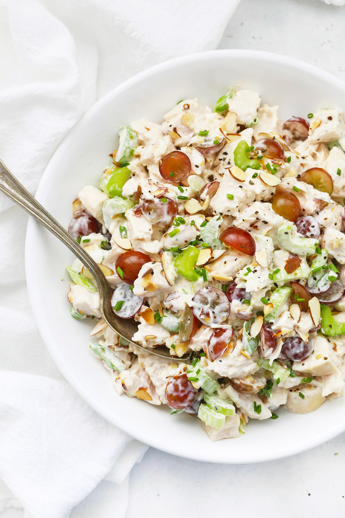 Close up overhead view of a bowl of classic chicken salad with grapes