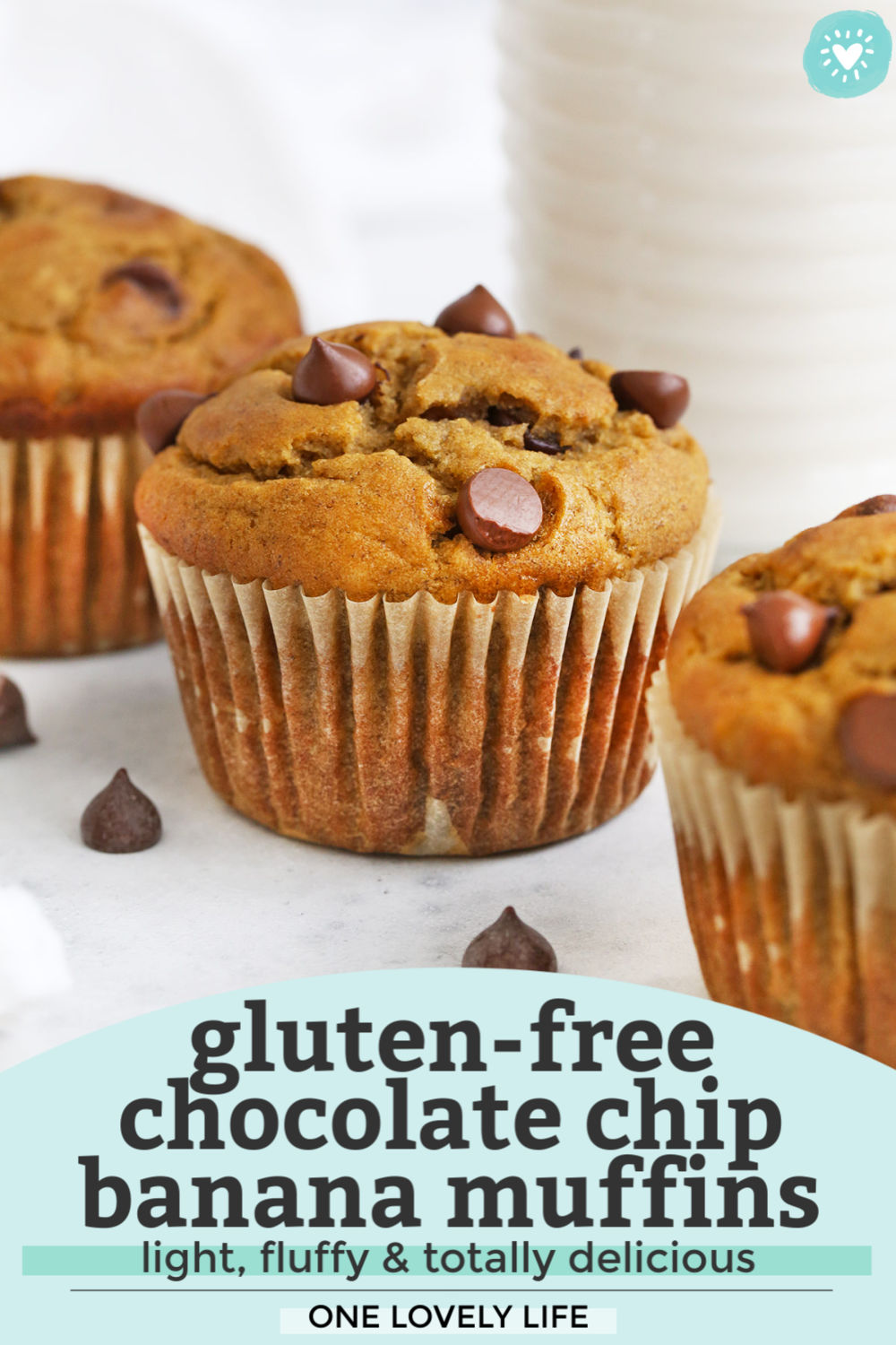 Three Chocolate Chip Banana Muffins on a White background with text overlay that reads "Gluten-Free Chocolate Chip Banana Muffins. Light, Fluffy & Totally Delicious. One Lovely Life."