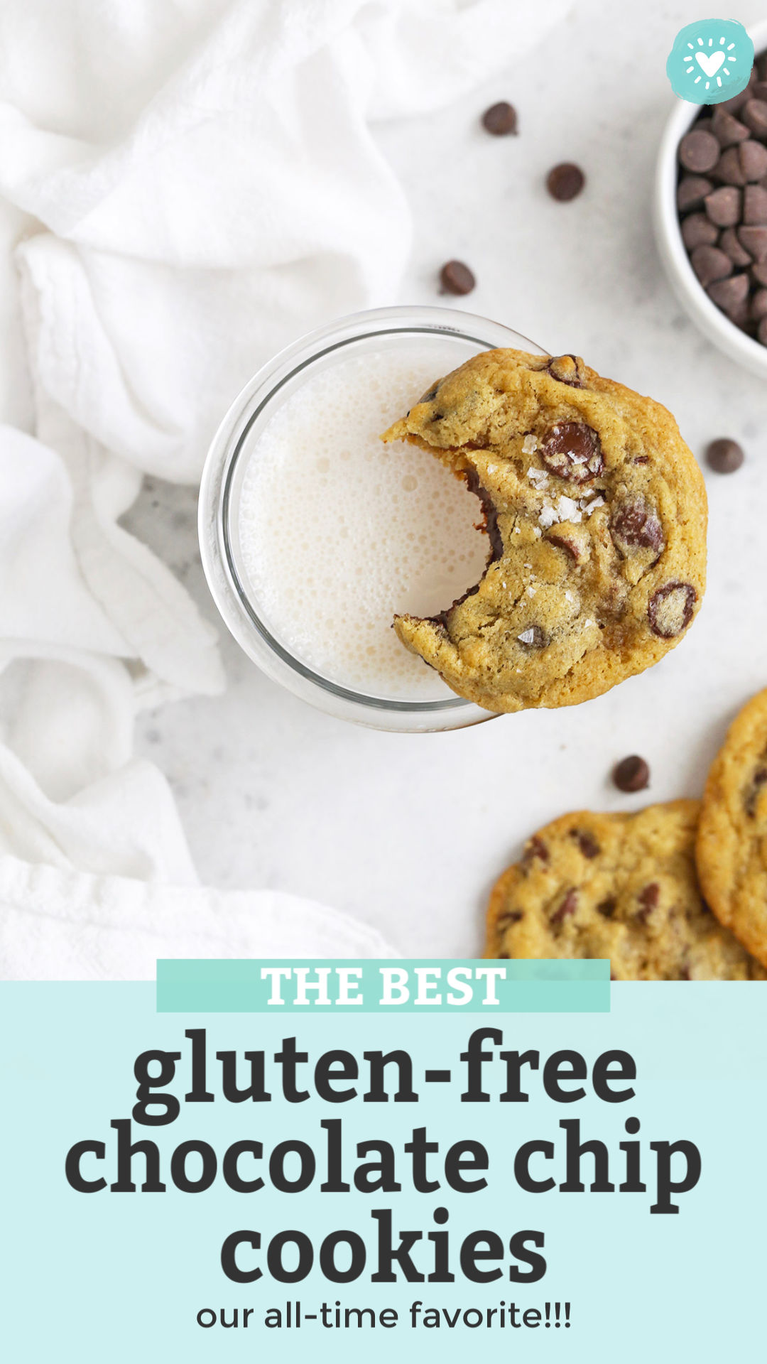 Overhead view of gluten-free chocolate chip cookie with a bite out of it resting on a glass of almond milk with text overlay that reads "The Best Gluten Free Chocolate Chip Cookies. Our all-time favorite!"