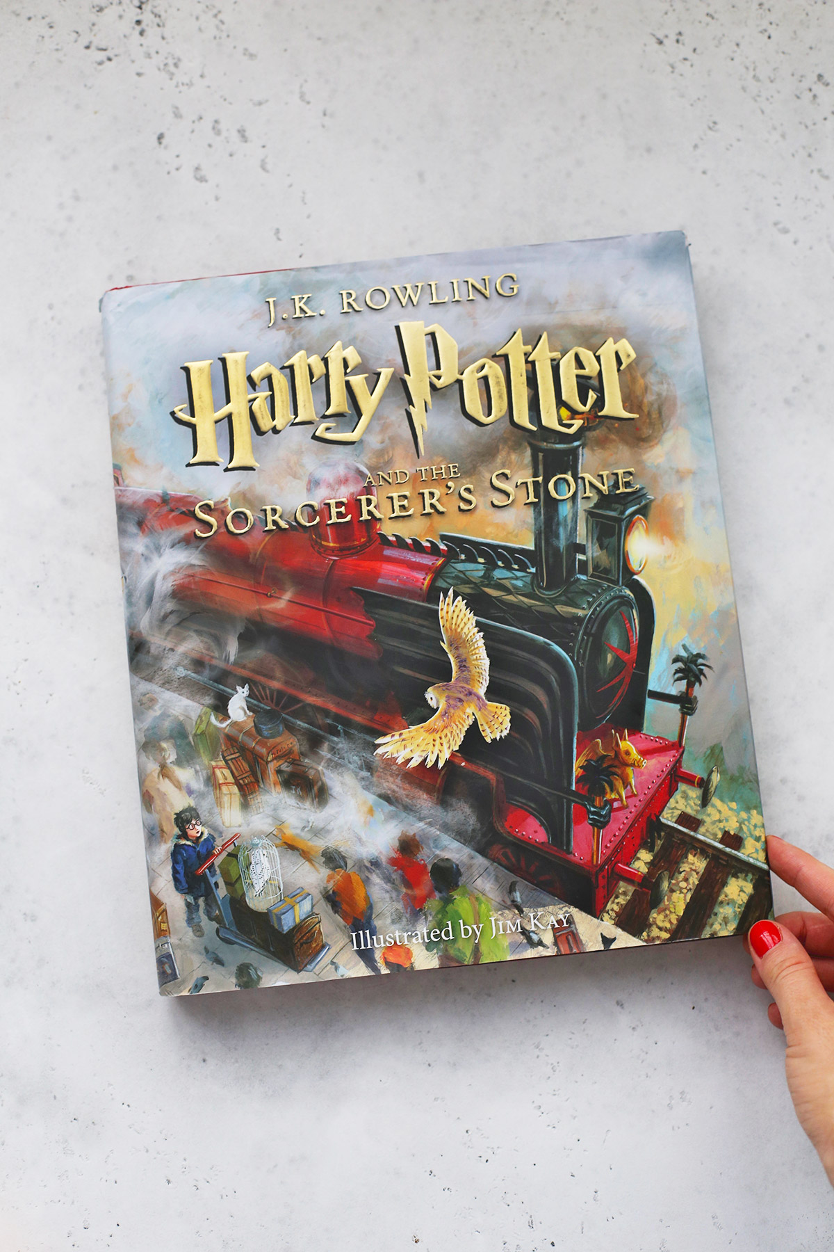 Illustrated copy of Harry Potter and the Sorcerer's Stone on a white background