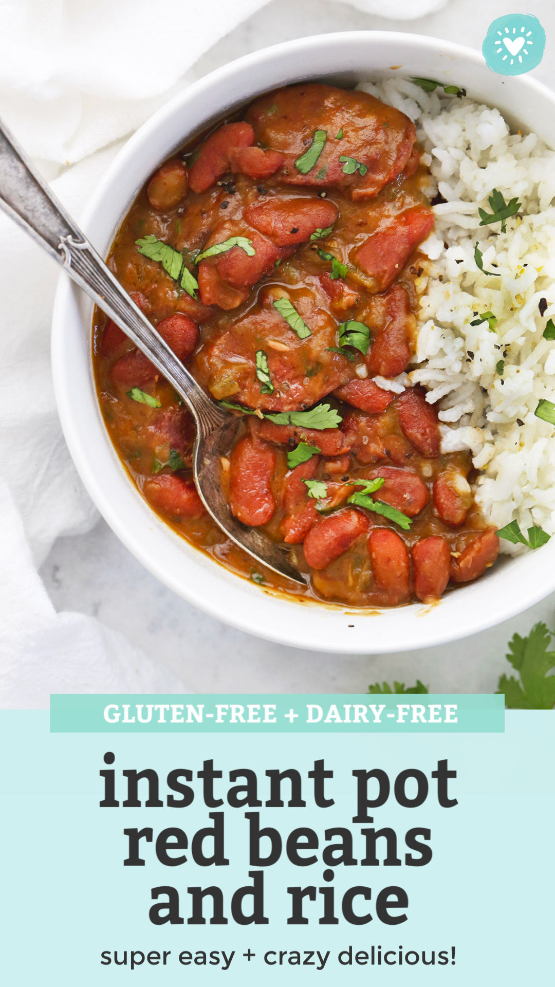 Close view of Instant Pot Red Beans and Rice in a bowl garnished with fresh herbs with text that reads "gluten-free + dairy-free Instant Pot red beans and rice. Super easy + crazy delicious!"