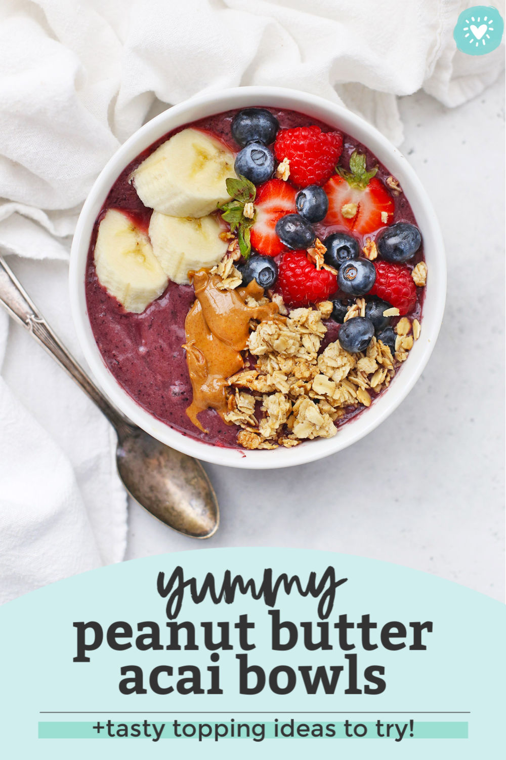 Peanut Butter Acai Bowl with Toppings on a White Background with a text overlay that reads "Yummy Peanut Butter Acai Bowls + Tasty Topping Ideas to Try!"