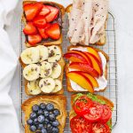 Overhead view of six Slices of Gluten-Free toast with different toppings on a wire cooling rack