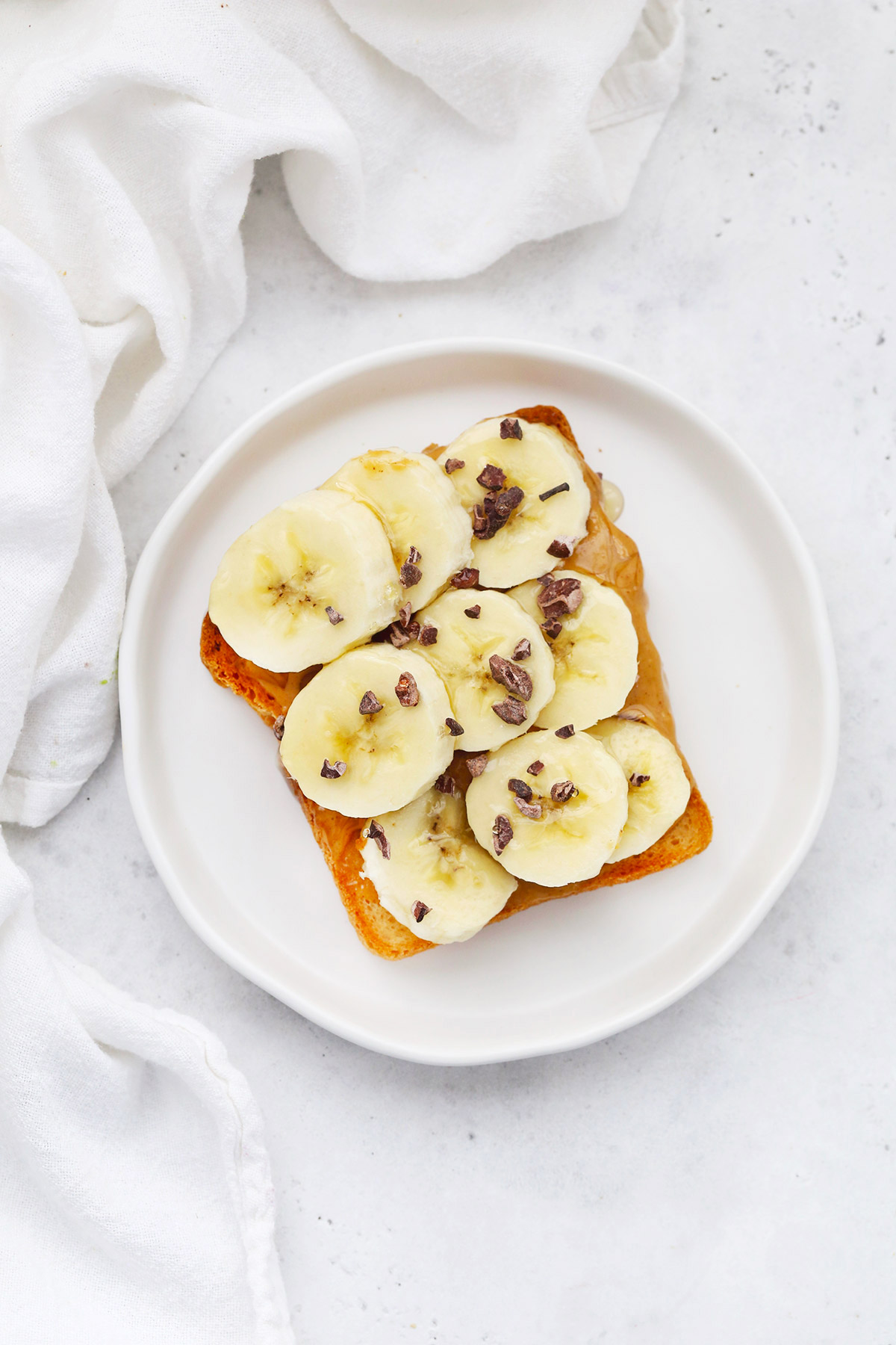 Gluten-Free Toast with Peanut Butter, Bananas, and Cacao Nibs