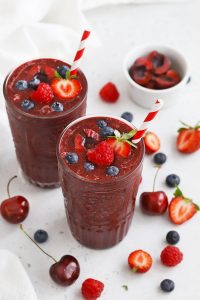 Front view of Cherry Berry Smoothies topped with fresh berries and cherries