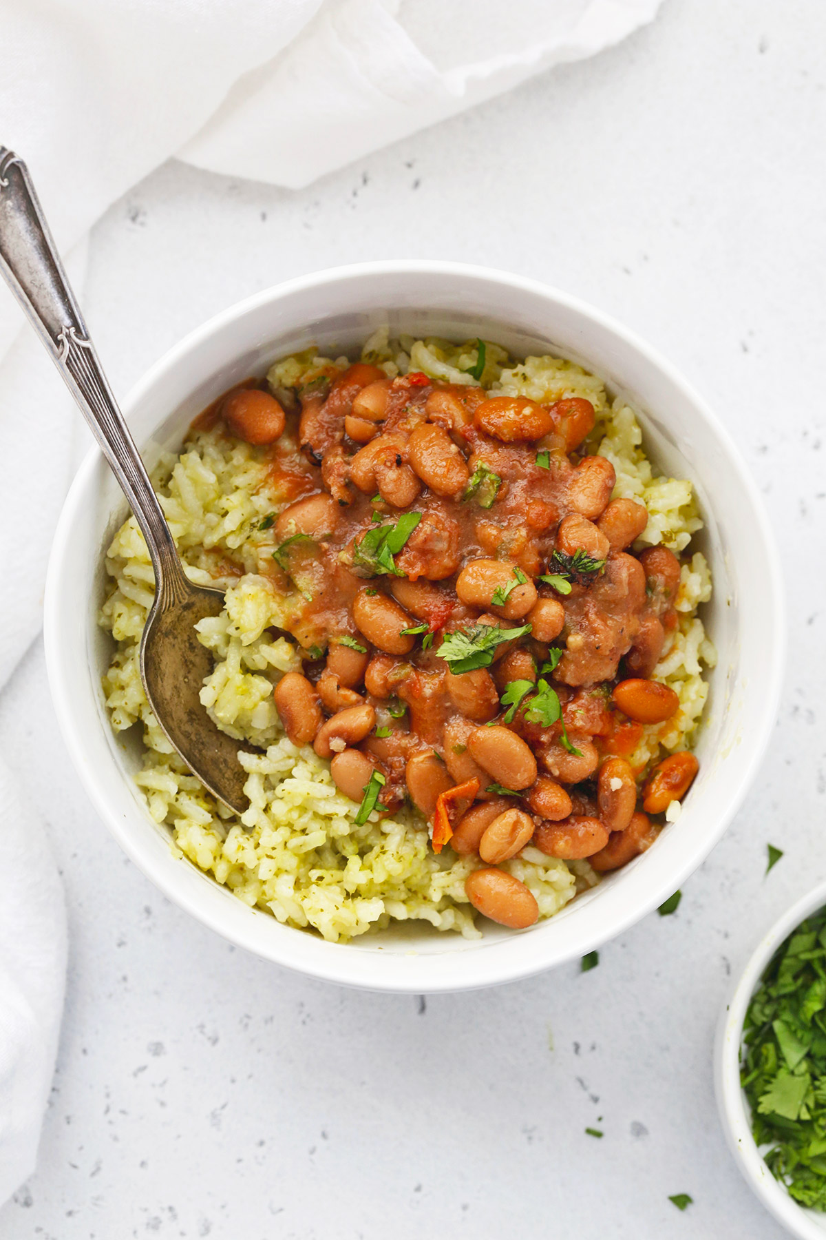 Mexican Green Rice (Arroz Verde) in a bowl with charro beans