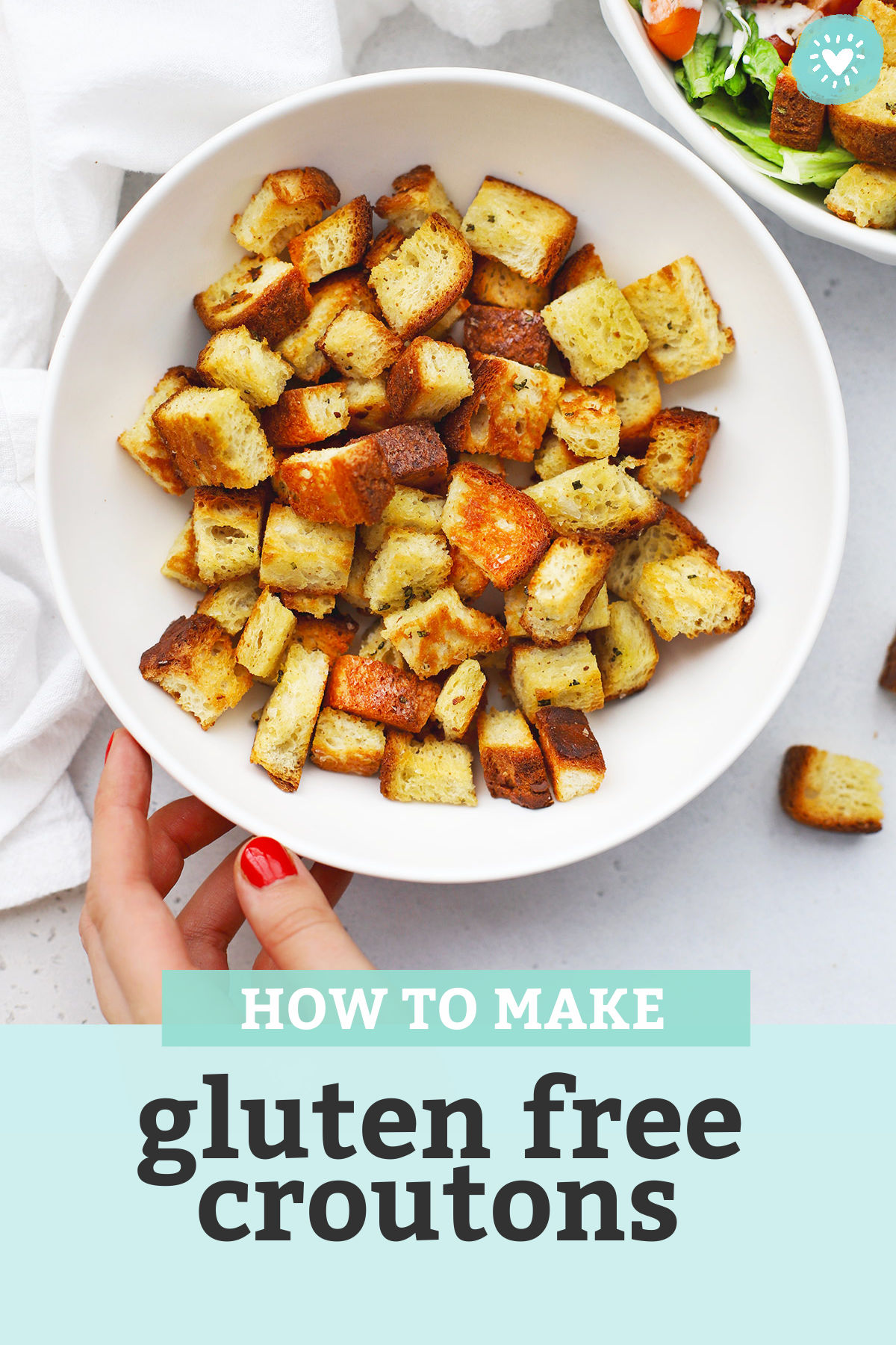 Setting down a bowl of gluten-free croutons next to a bowl of salad with text overlay that reads "How to Make Gluten-Free Croutons"