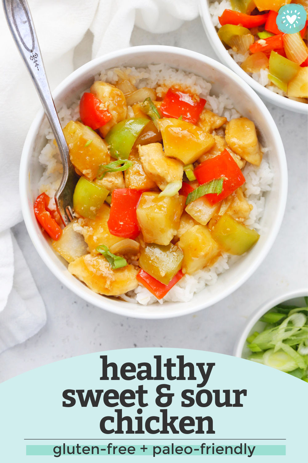 Gluten-free, paleo-friendly Healthy Sweet and Sour Chicken in a white bowl with text overlay that says "healthy sweet & sour chicken. Gluten-Free + Paleo-Friendly"