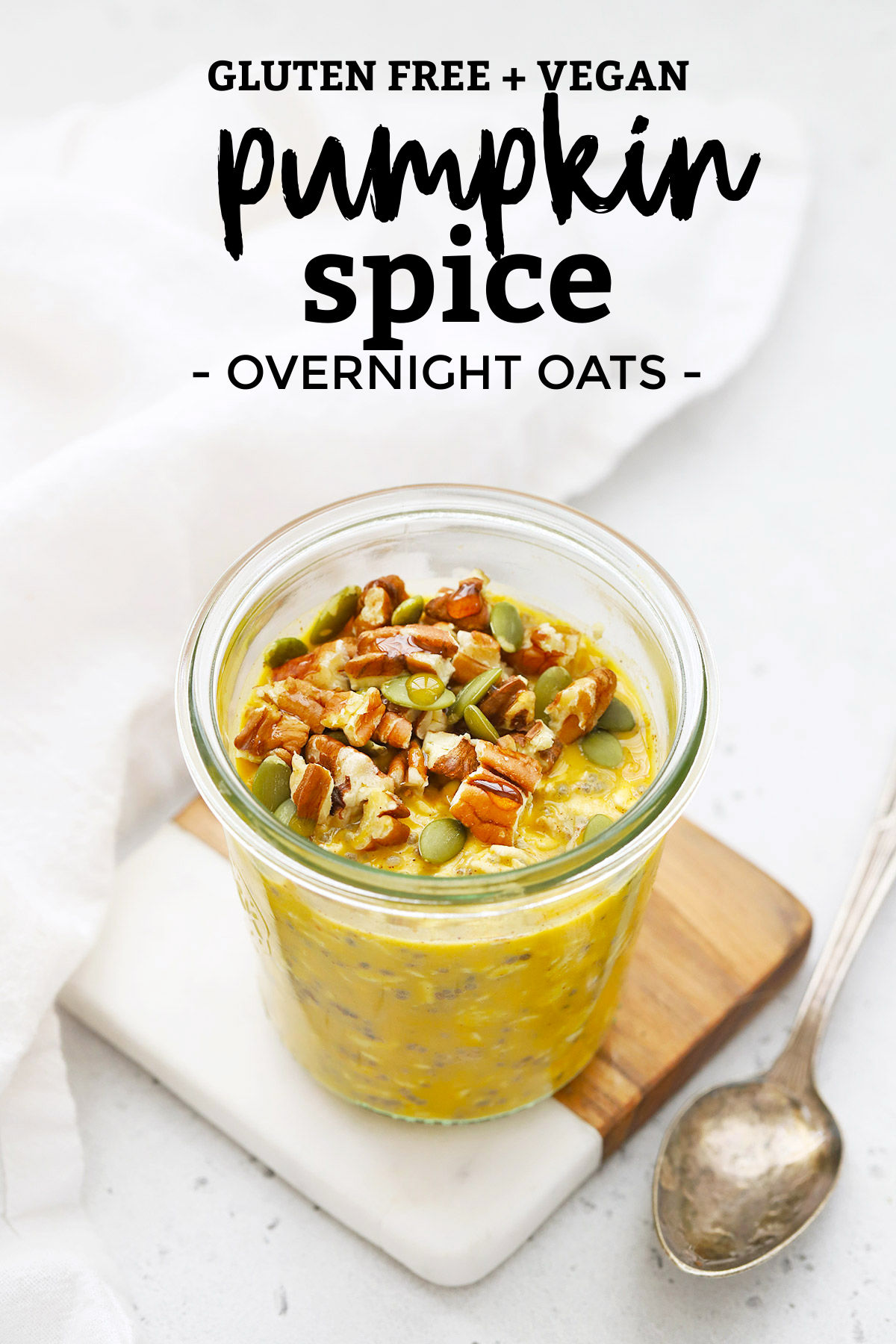 Jar of pumpkin overnight oats topped with pecans and pumpkin seeds with text overlay that reads "gluten-free + vegan Pumpkin spice Overnight Oats"
