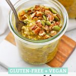 Spoon dipped into a jar of Pumpkin Pie Overnight Oats topped with pecans and pumpkin seeds with text overlay that reads "Gluten-Free + Vegan Pumpkin Overnight Oats"