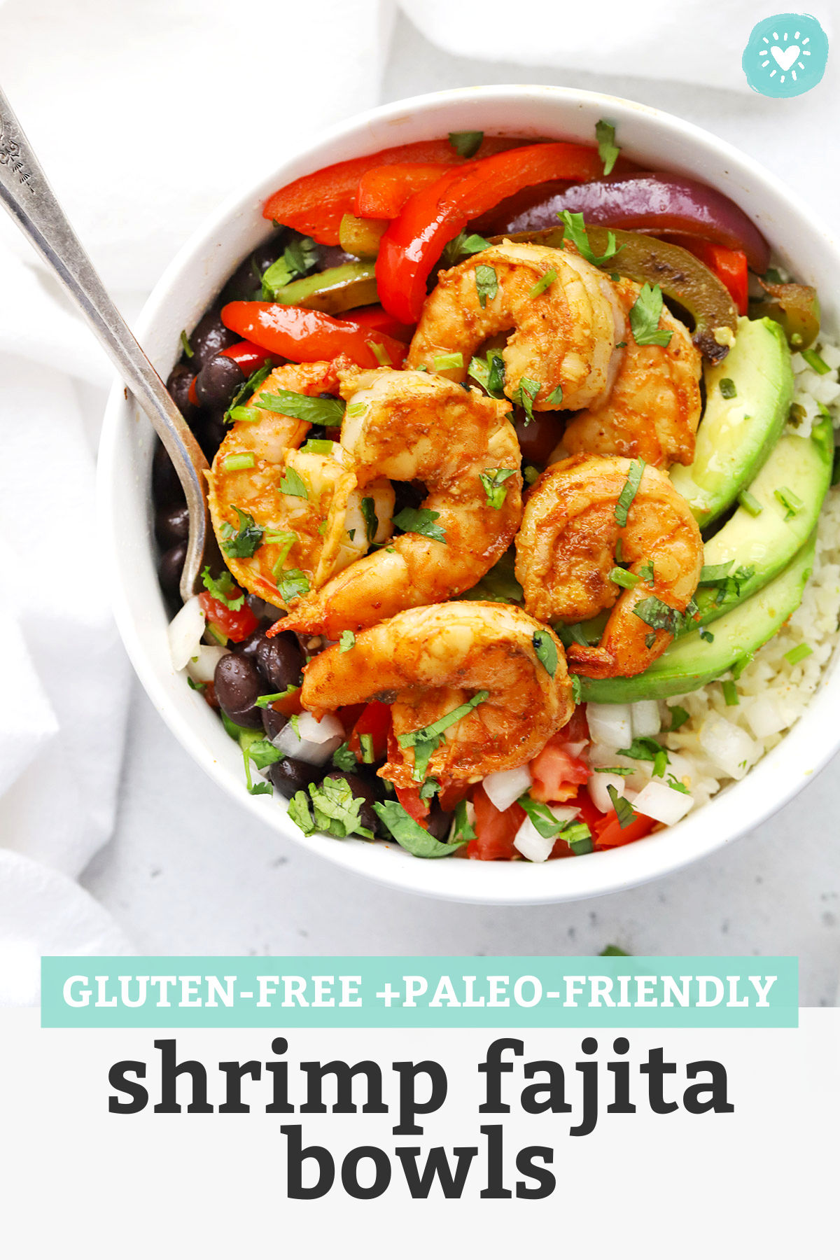 Gluten Free Shrimp Fajita Bowls with avocado, black beans, and pico de gallo with text overlay that reads "Gluten-Free + Paleo-Friendly Shrimp Fajita Bowls"