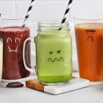 Three monster face smoothies on a white background