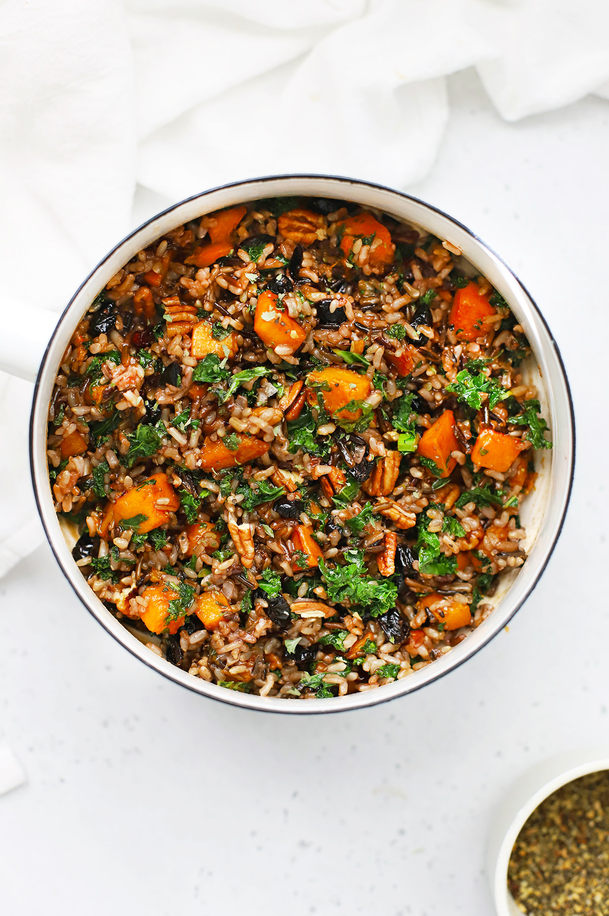 Overhead view of a saucepan of Wild Rice Pilaf with Butternut Squash, Kale, Dried Cranberries, and Pecans