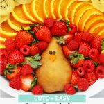 Overhead view of Thanksgiving Fruit Plate shaped like a turkey with text overlay that reads "Cute + Easy Thanksgiving Turkey Fruit Plate: Simple + Fun + Adorable!"