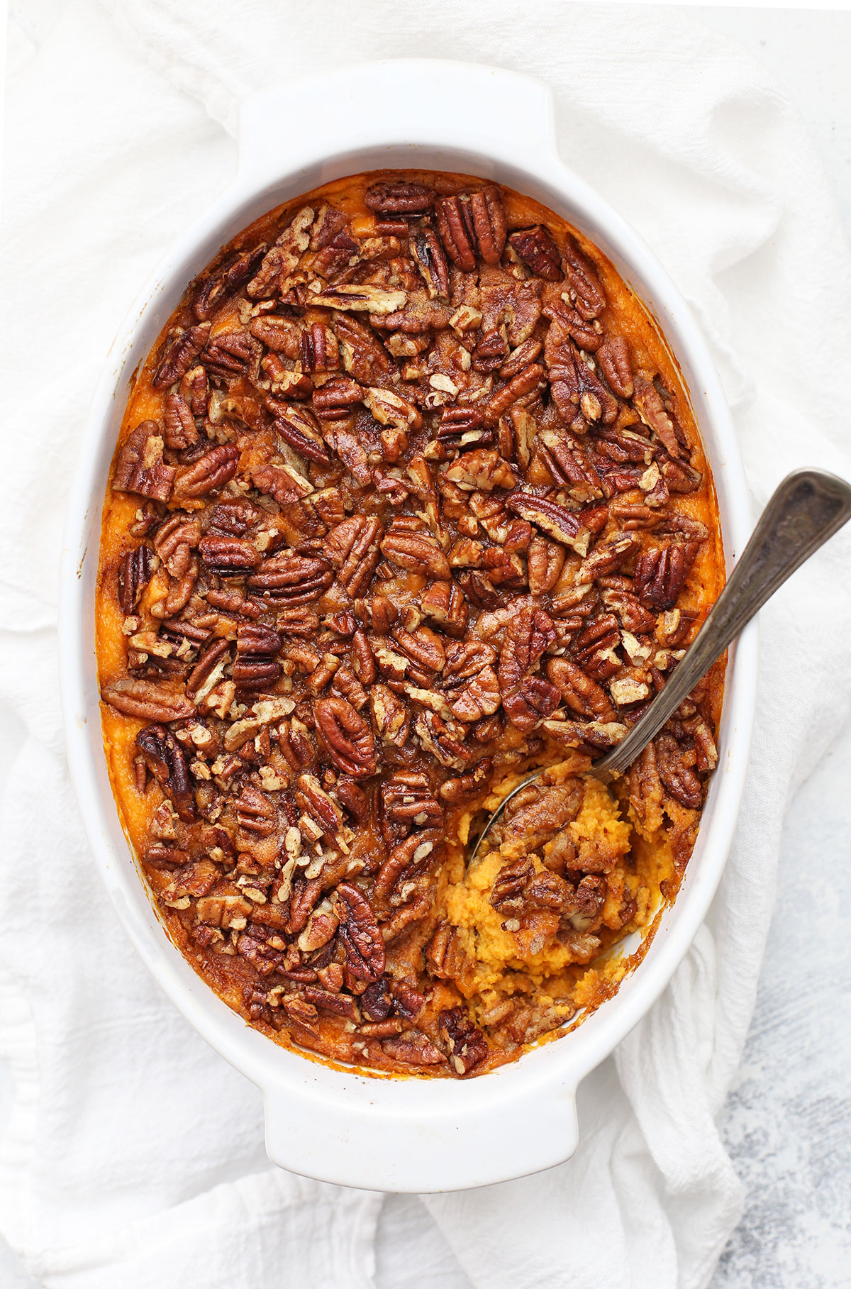 Overhead view of paleo sweet potato casserole with a spoon in it.