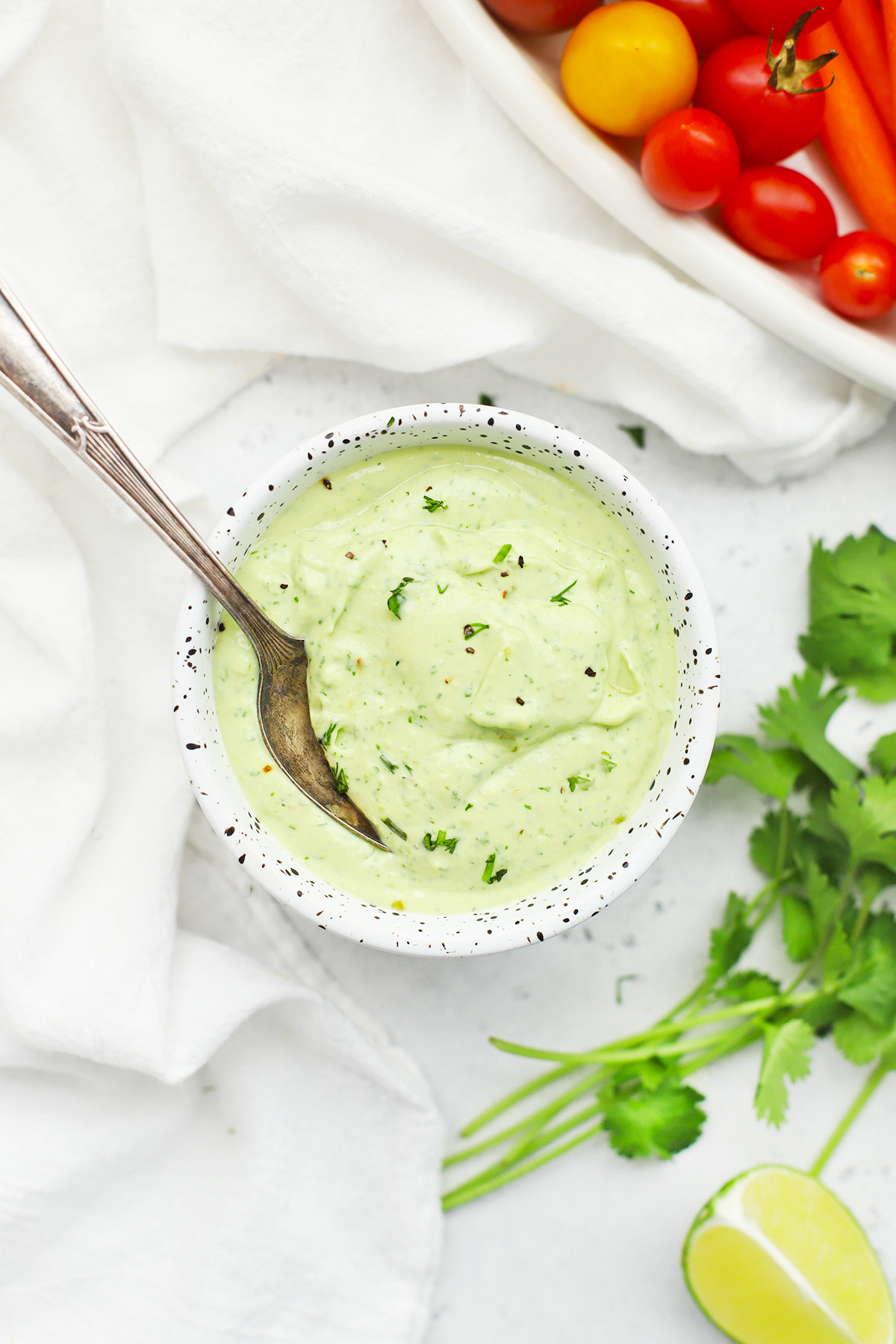 Overhead view of a speckled bowl of vegan or paleo avocado ranch