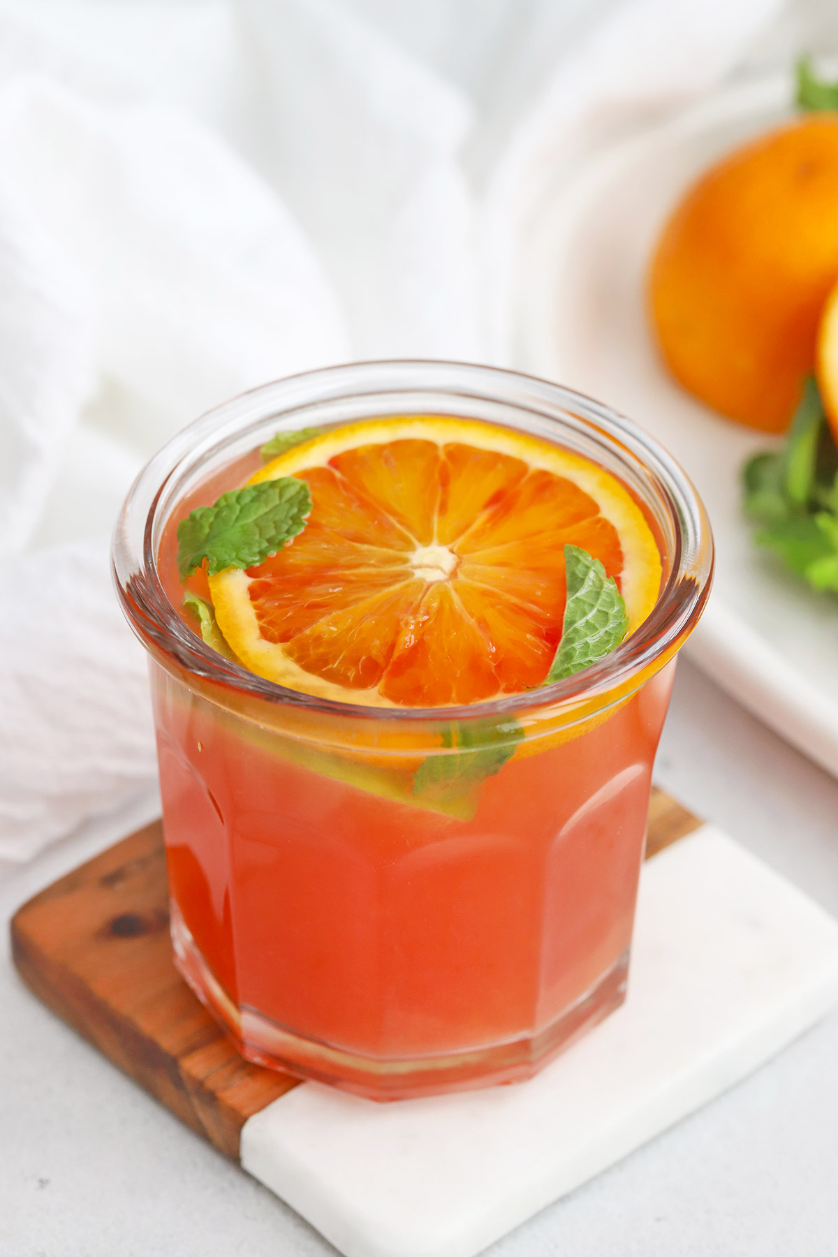 Front view of a blood orange mocktail garnished with fresh mint