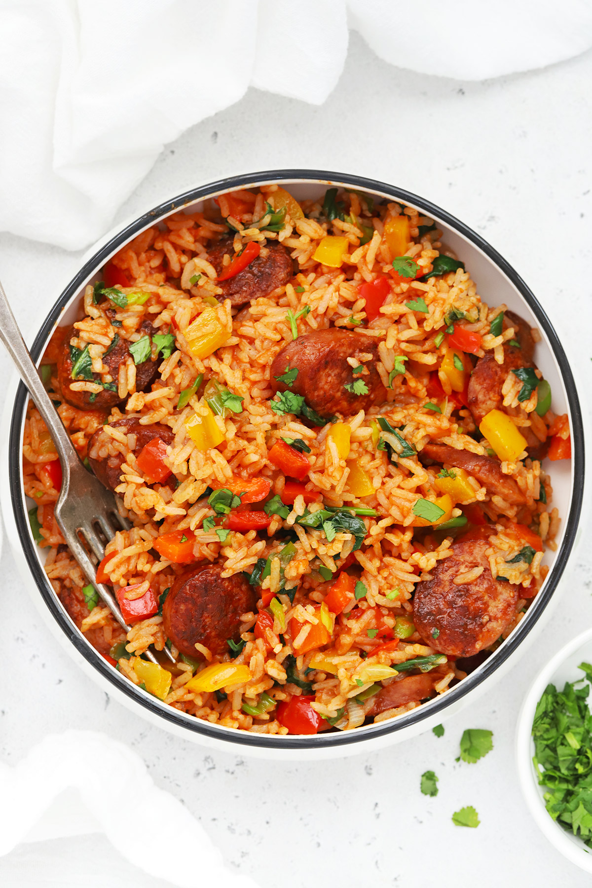 Overhead view of a bowl of Cajun Sausage and Rice Skillet on a white background