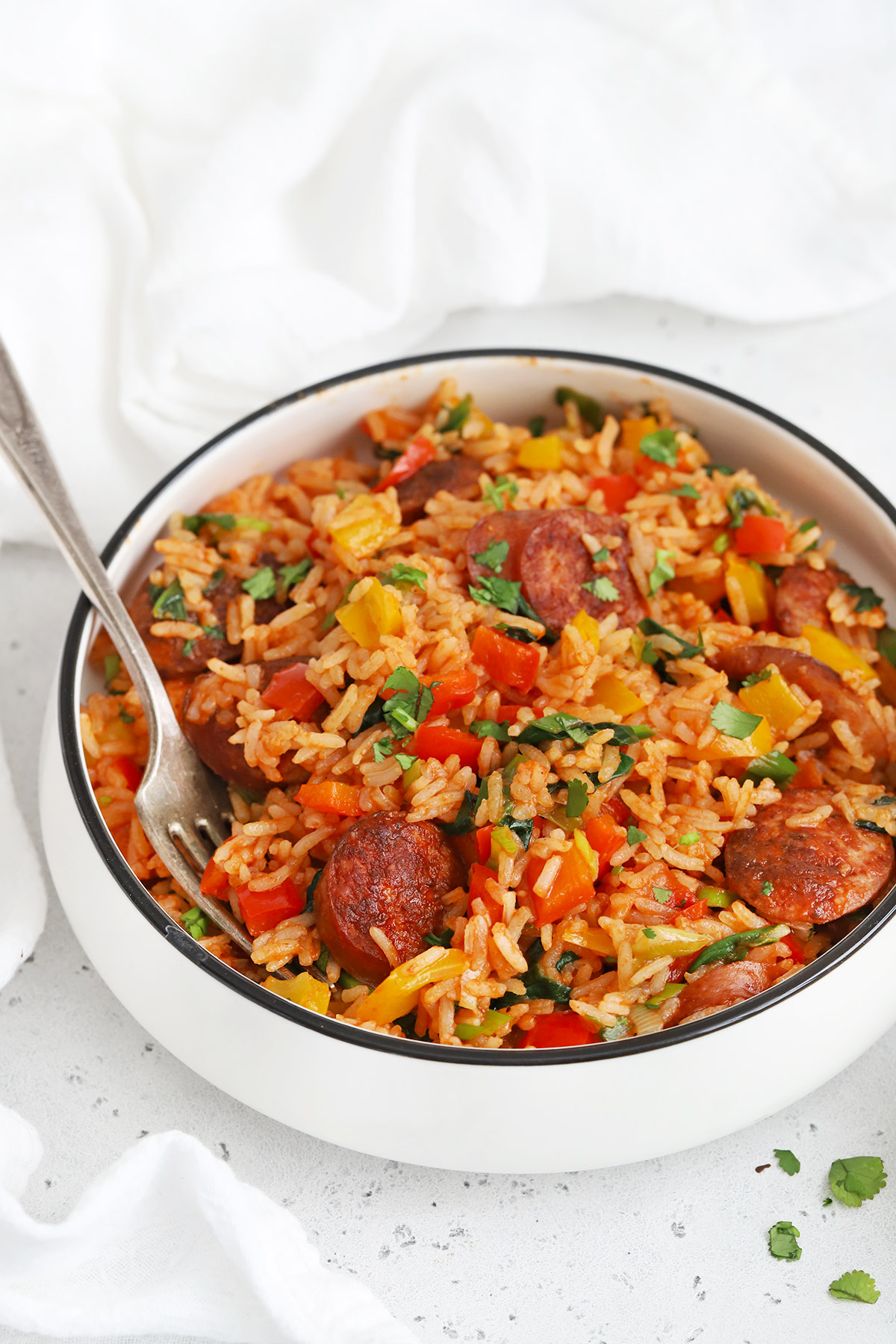 Front view of a bowl of Cajun Sausage and Rice Skillet on a white background