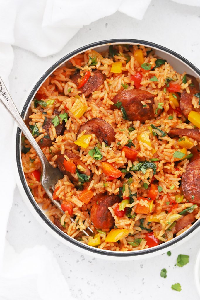 Close-up overhead view of a bowl of Cajun Sausage and Rice Skillet on a white background