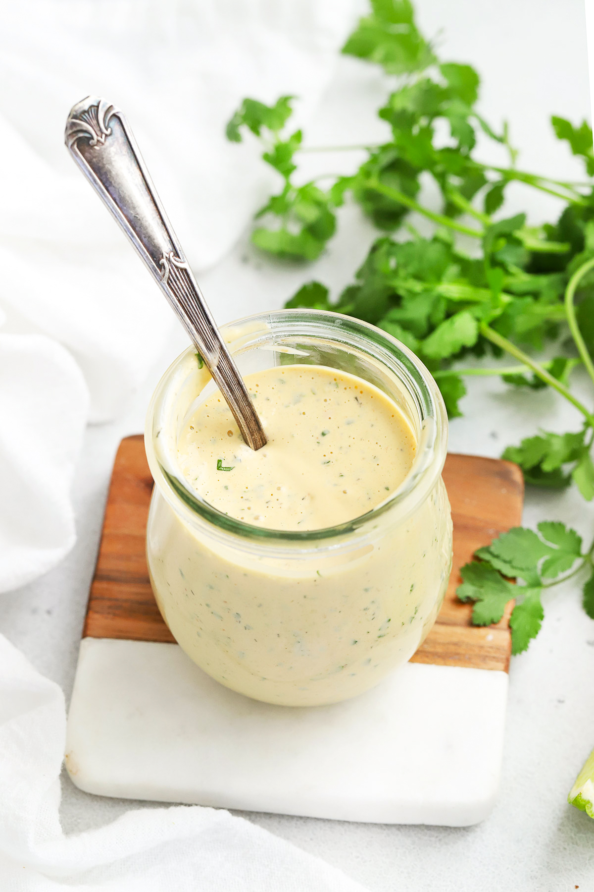 Front view of a jar of chipotle ranch dressing with a spoon in it.