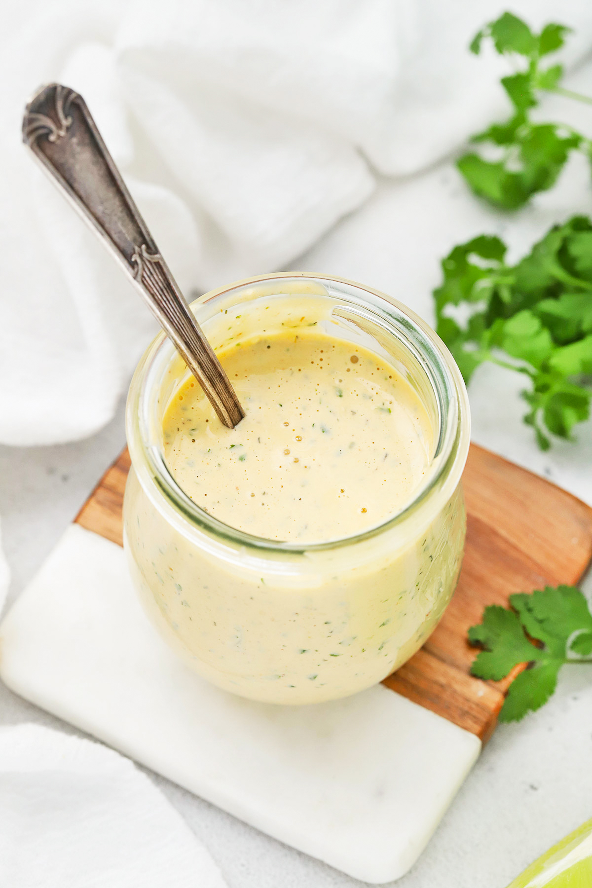 Front view of a jar of chipotle ranch dressing with a spoon in it.