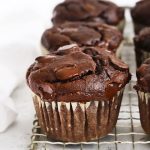 Close up front view of gluten-free chocolate banana muffins on a cooling rack