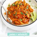 Front view of Paleo Slow Cooker Butter Chicken with rice. Small bowls of lime wedges off to the side with text overlay that reads "paleo + whole30 Slow Cooker Butter Chicken"