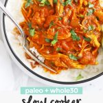 Overhead view of Paleo Slow Cooker Butter Chicken with rice. Small bowls of lime wedges off to the side with text overlay that reads "paleo + whole30 Slow Cooker Butter Chicken"