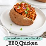 Front view of a BBQ Chicken Stuffed Baked Sweet Potato on a white plate with text overlay that reads "gluten-free + paleo-friendly BBQ Chicken Sweet Potatoes. An Easy + Delicious Dinner Idea"