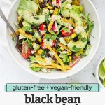 Overhead view of a white bowl of vegetarian black bean taco salad with crispy torilla strips and chipotle ranch dressing with text overlay that reads "gluten-free + vegan-friendly black bean taco salad with chipotle ranch dressing"