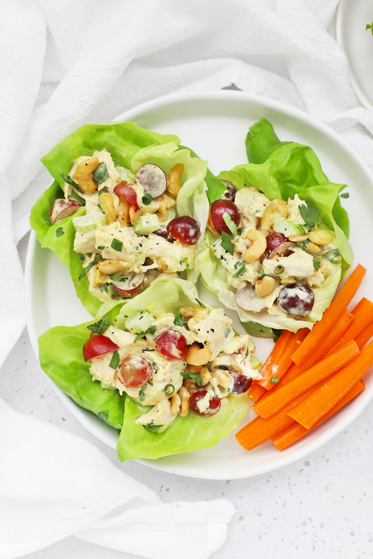 Close up Overhead view of curry chicken salad lettuce wraps on a white background