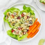 Overhead view of curry chicken salad lettuce wraps on a white background
