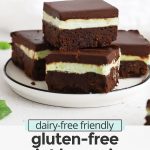 Front view of a plate stacked with gluten free mint brownies on a white background with text overlay that reads "dairy-free friendly gluten free mint brownies: fudgy + rich + delicious!"