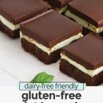 Front view of squares of gluten free mint brownies on a white background with text overlay that reads "dairy-free friendly gluten free mint brownies: fudgy + rich + delicious!"