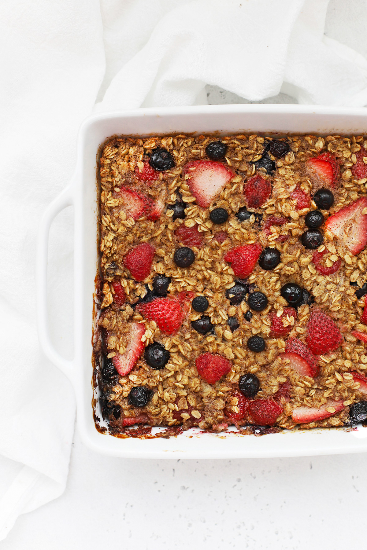 Overhead view of a pan of mixed berry baked oatmeal freshly removed from the oven