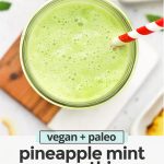 Close up overhead view of pineapple mint smoothie in a glass with a red striped straw with text overlay that reads "vegan + paleo pineapple mint smoothie. Fresh + easy + delicious"