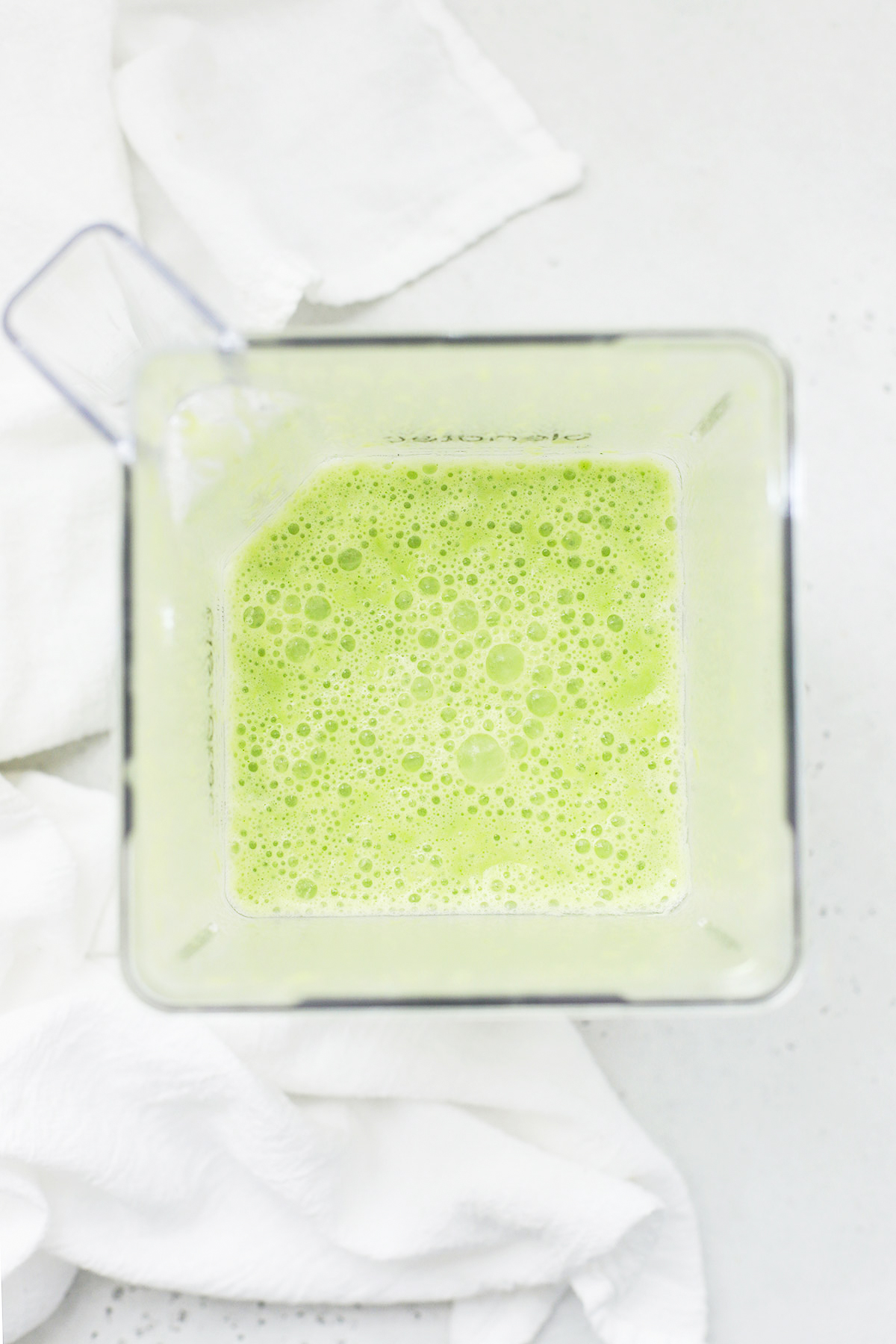 Overhead view of a blender of pineapple mint smoothie