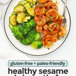 Overhead view of a plate of easy sesame shrimp with broccoli and zucchini on a white background with text overlay that reads "gluten-free + paleo-friendly healthy sesame shrimp stir-fry. Quick + easy + yumm!"