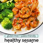 Close up Front view of a plate of easy sesame shrimp with broccoli and zucchini with text overlay that reads "gluten-free + paleo-friendly healthy sesame shrimp stir-fry. Quick + easy + yumm!"