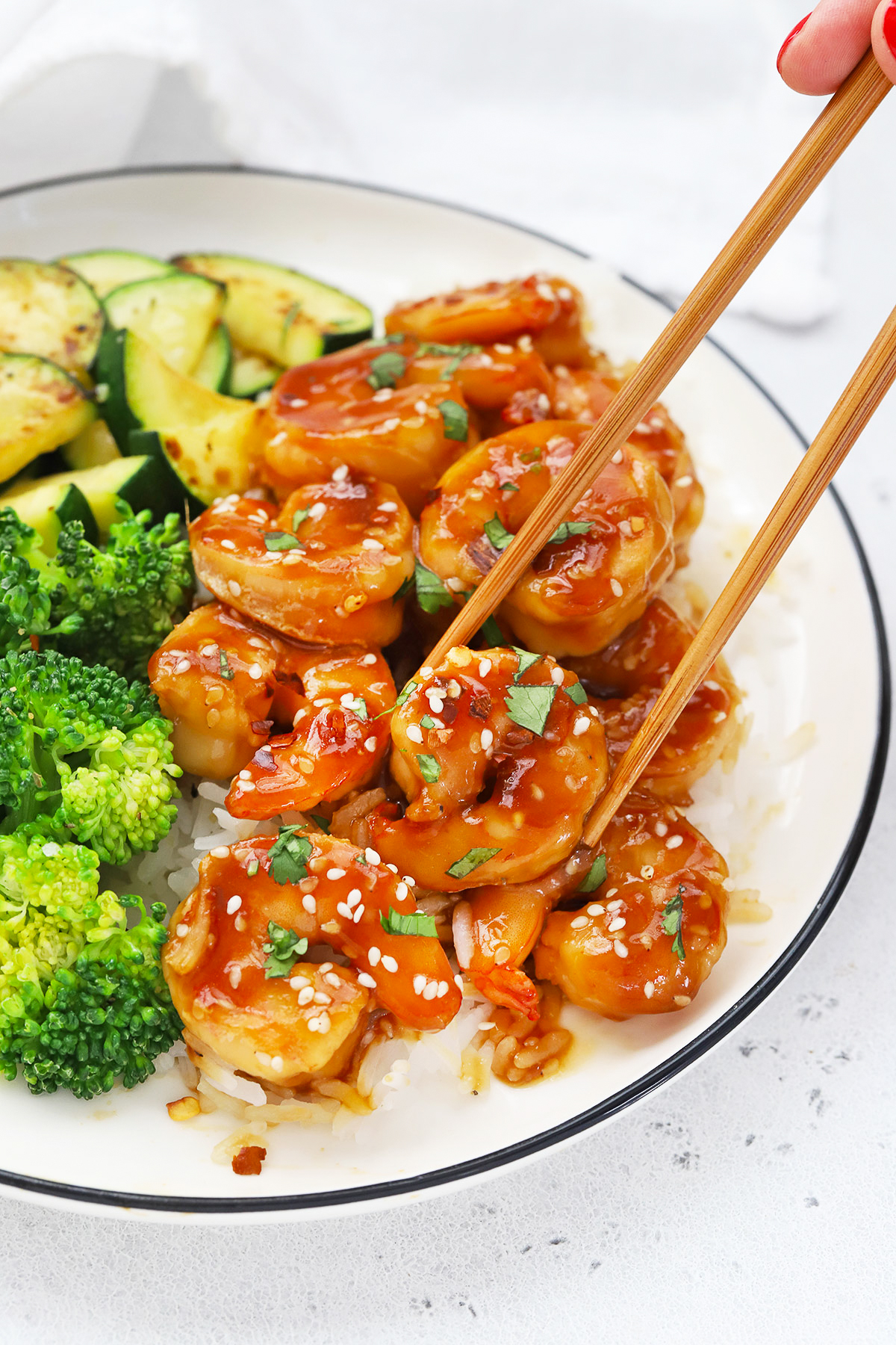 Close up Front view of a plate of easy sesame shrimp with broccoli and zucchini