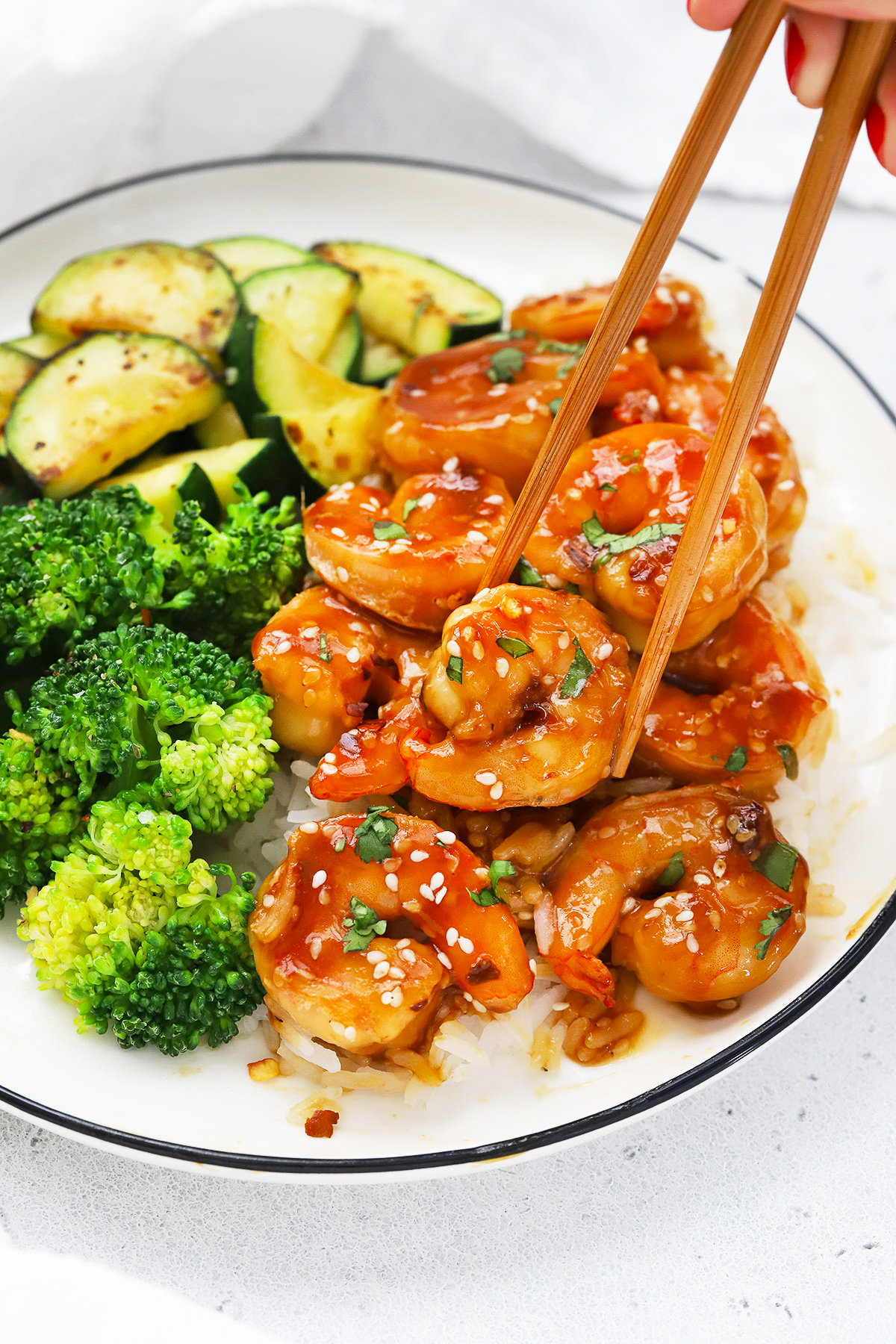 Front view of a plate of easy sesame shrimp with broccoli and zucchini