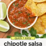 Overhead view of a bowl of chipotle salsa on a wooden board with tortilla chips with text overlay that reads "quick + easy chipotle salsa: smoky + flavorfu; + delicious"