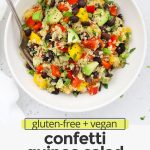 Overhead view of a bowl of Confetti Quinoa Salad in a white bowl on a white background with text overlay that reads "gluten-free + vegan-friendly confetti quinoa salad: fresh + light + easy"