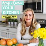 Woman holding up a kitchen cleaning checklist with text overlay that reads "how to deep clean your kitchen +free printable checklist"
